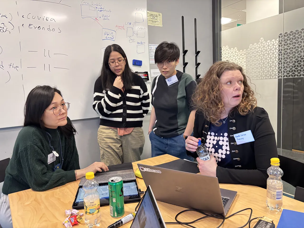 Four people attending a hackathon in an office